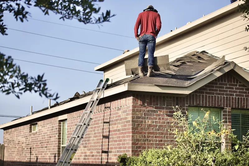 Professional roofer working on a residential roof in Morning Sun